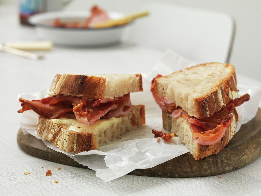 Sandwich With Cheese And Crispy Bacon, Cut Into Two Parts Photograph by Hugh Johnson