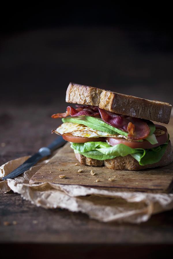 Sandwich With Fried Egg, Bacon, Avokado And Tomato Photograph by Malgorzata Laniak