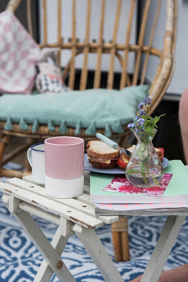 Sandwiches, Coffee Cups, Magazines And Vase Of Flowers On Folding Table Outside Photograph by Jelena Filipinski