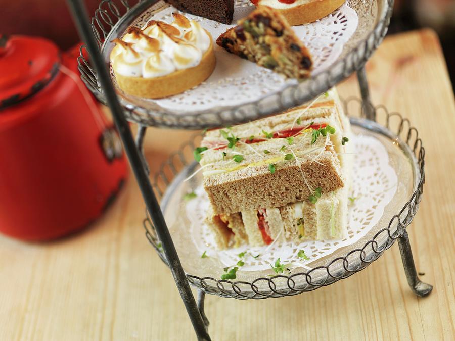 Sandwiches On A Cake Stand For Tea Time Photograph by Rob Whitrow