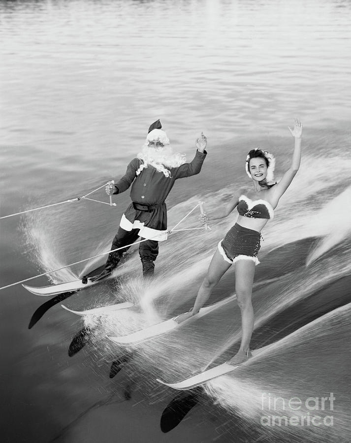 Santa Claus Water Skiing With Female Photograph by Bettmann