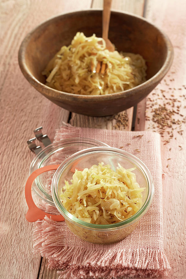 Sauerkraut Made From Pointed Cabbage In A Wooden Bowl And A Jar Photograph by Teubner Foodfoto
