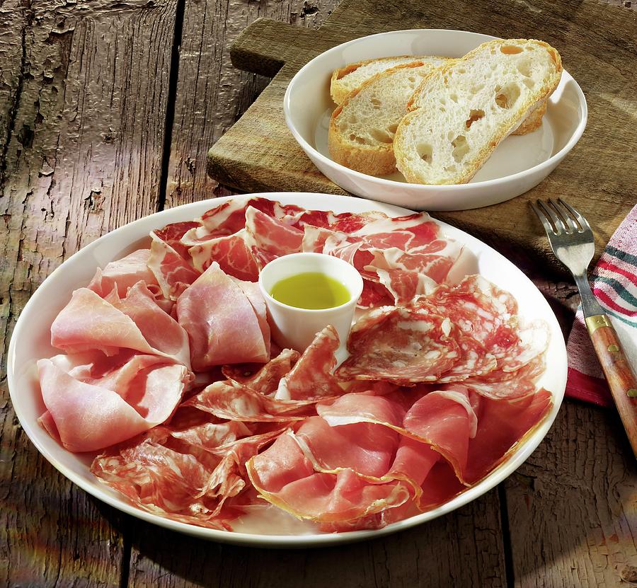 Sausage And Ham Platter With Olive Oil And White Bread Photograph by Foodfoto Kln