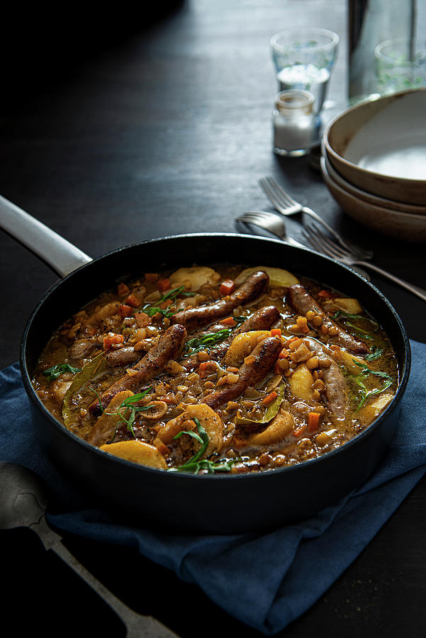 Sausage Casserole Cooked In Cider With Lentils Apples And Tarragon Photograph by Magdalena Hendey