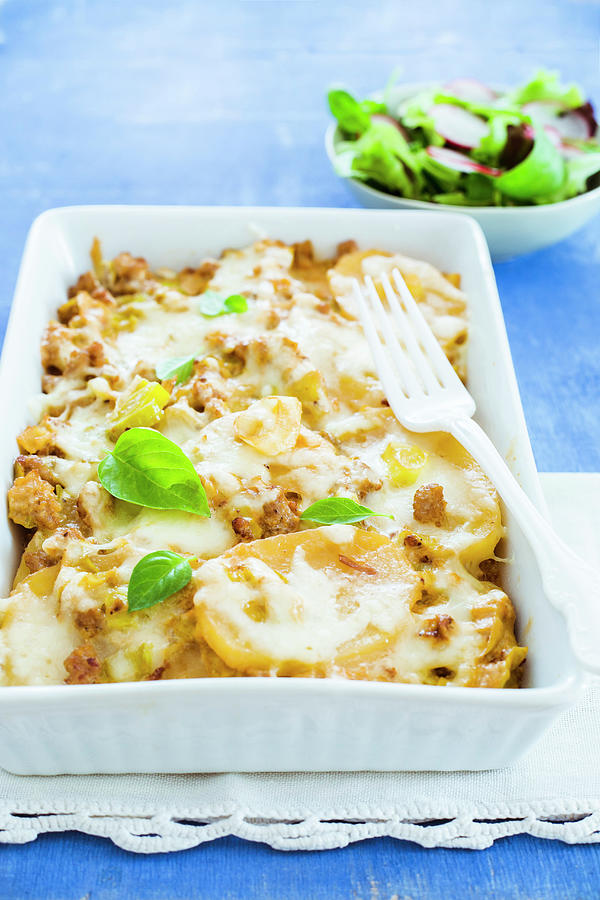 Sausage, Leek And Potatoe Casserole In A Baking Pan Served With Salad Photograph by Maricruz Avalos Flores