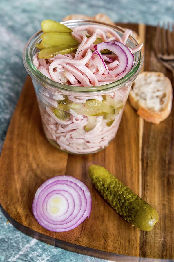 Sausage Salad With Red Onion And Gherkins In A Glass On A Wooden Board Photograph by Sandra Rsch