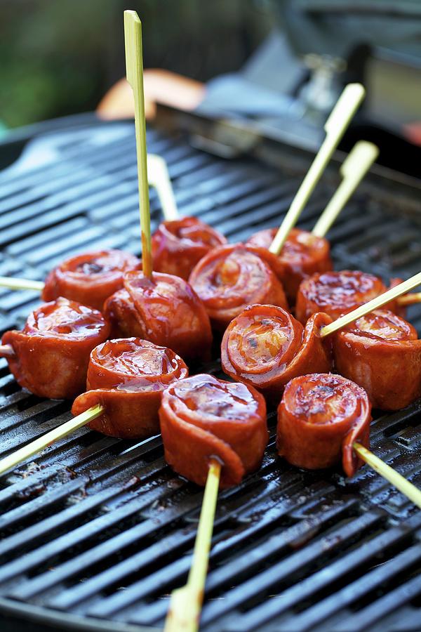 Sausage Snails On Skewers On A Barbecue Photograph by Herbert Lehmann