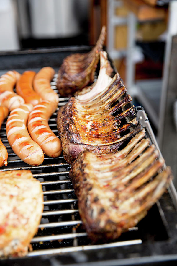 Sausages And Ribs On A Grill Rack Photograph by Claudia Timmann