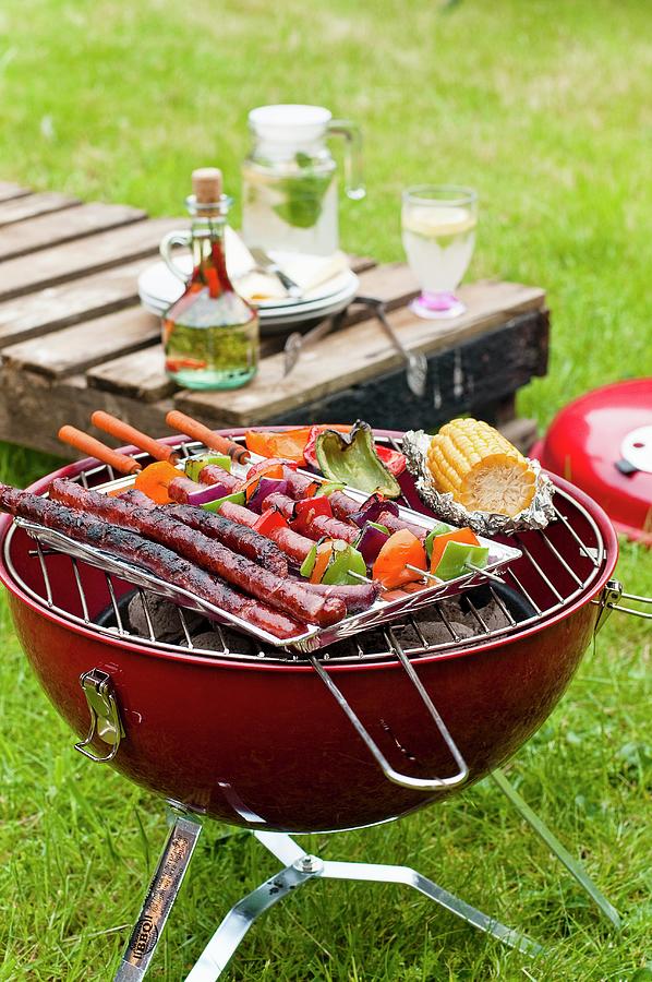 Sausages And Vegetables On A Charcoal Barbecue Photograph by Tomasz Jakusz