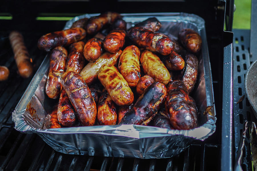 Sausages In An Aluminium Tray On A Gas Grill Photograph by Lara Jane Thorpe