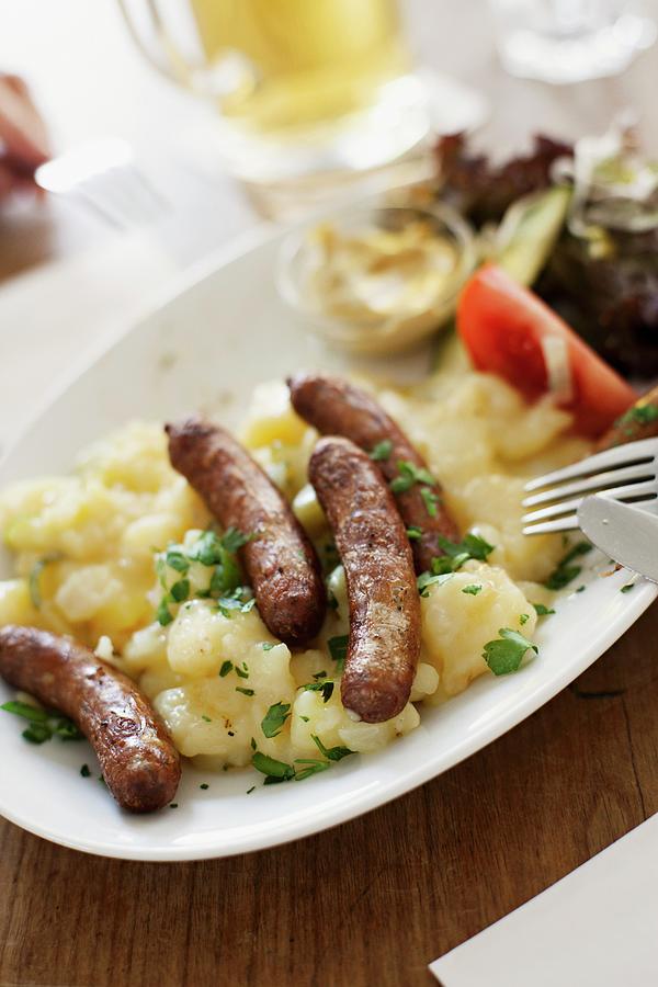 Sausages On A Bed Of Potato Salad Photograph by Alex Hinchcliffe