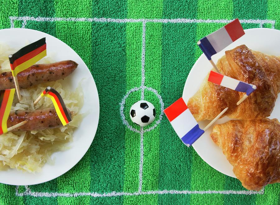 Sausages With Cabbage germany And Croissants france With Football-themed Decoration Photograph by Schindler, Martina