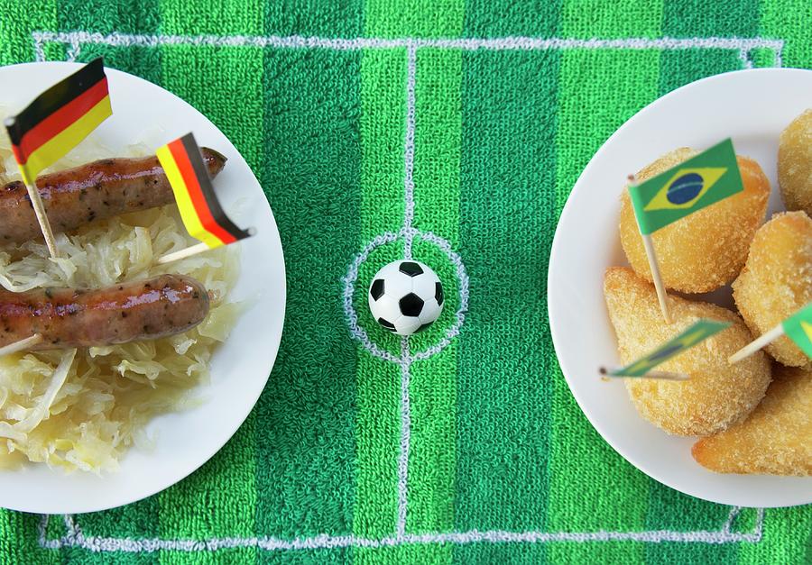 Sausages With Cabbage germany And Salgadinhos brazil With Football-themed Decoration Photograph by Schindler, Martina
