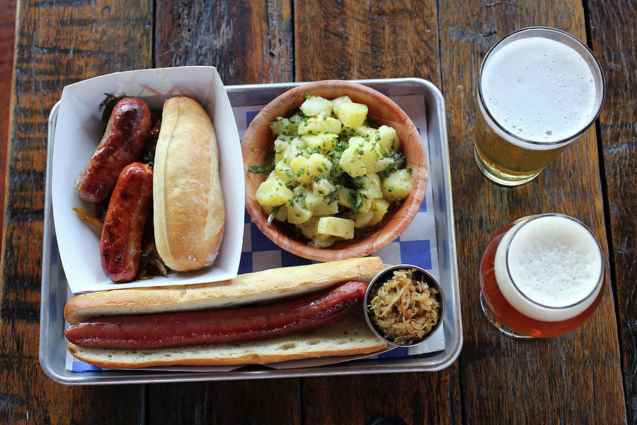 Sausasges, Footlong Hot Dog, German Potato Salad, Saurkraut And Beer At A German-style Beer Garden Photograph by Doug Schneider Photography