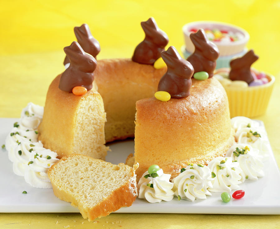 Savarin For Easter With Cream, Mini Chocolate Bunnies And Colourful Easter Eggs Photograph by Teubner Foodfoto