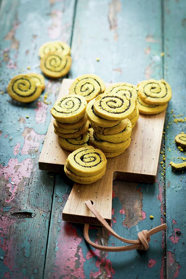 Savoury Curry And Poppyseed Pinwheels On A Chopping Board Photograph by Manuela Rther