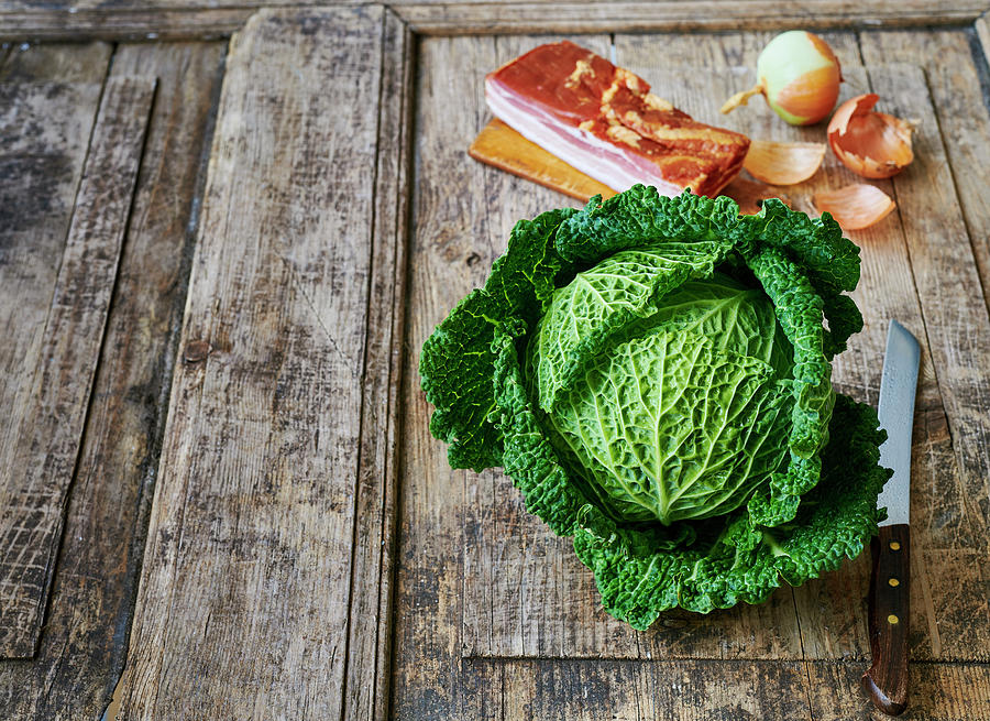 Savoy Cabbage, Bacon And Onions On A Wooden Background Photograph by Stefan Schulte-ladbeck