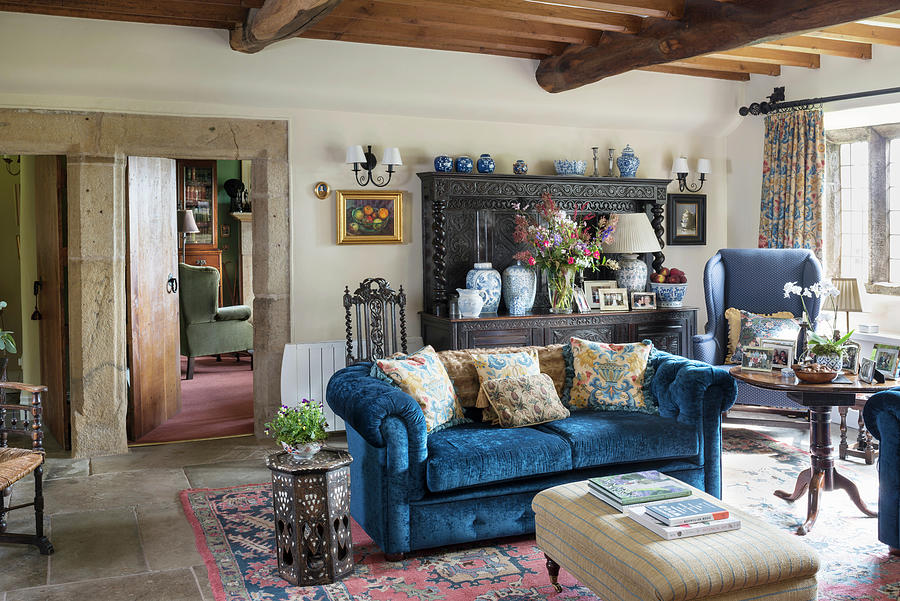 Scatter Cushions On Blue Sofa And Antique Dresser In Rustic Living Room Wit Wood-beamed Ceiling Photograph by Brian Harrison