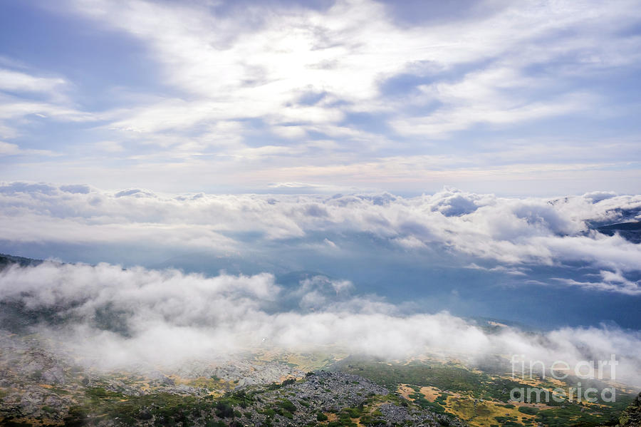 Scene of a winter cloudy sky from the top of a mountain peak. Photograph by Joaquin Corbalan