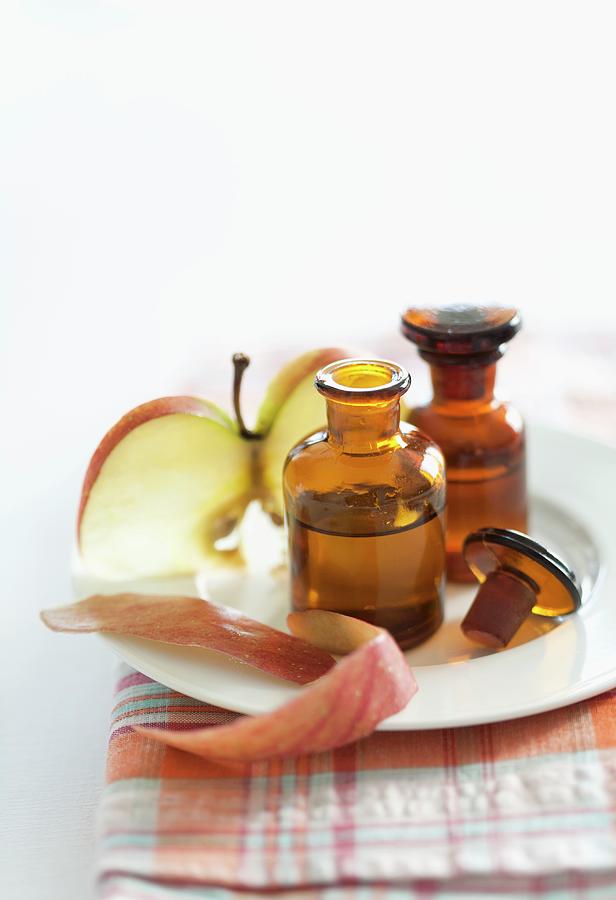 Scented Apple Oil And A Slice Of Apple Photograph by Schindler, Martina