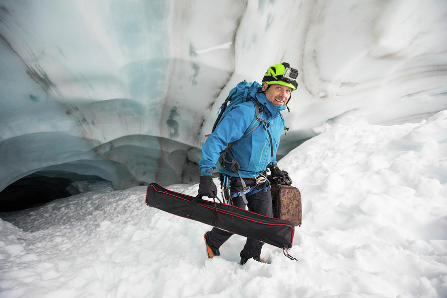 Nature Photograph - Scientist Carries Gear Out Of A Glacier Cave, British Columbia, Canada by Cavan Images