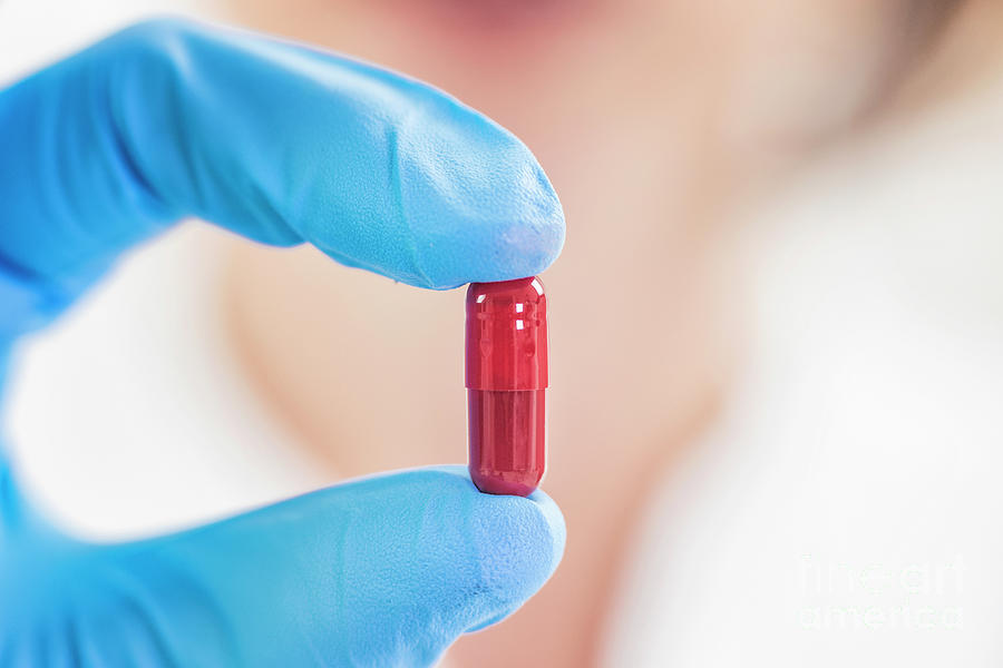 Scientist Holding A Red Pill Photograph by Microgen Images/science Photo Library