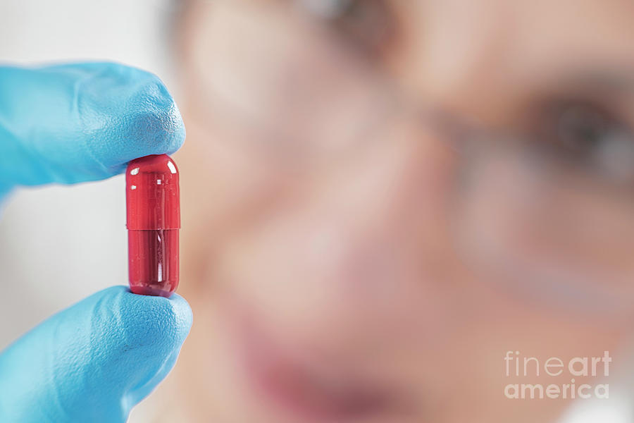 Scientist Holding Red Pill Photograph by Microgen Images/science Photo Library