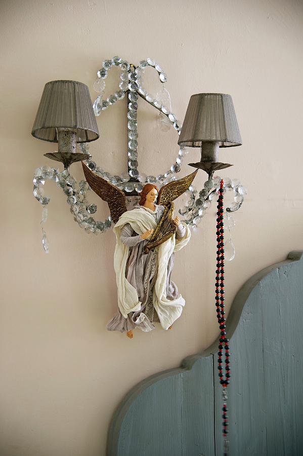 Sconce Lamp With Small Fabric Lampshades And Painted Angel Figurine Photograph by Winfried Heinze