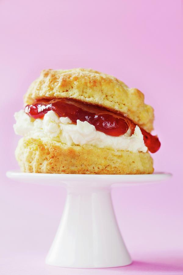 Scone With Clotted Cream And Strawberry Jam On A Mini Cake Stand Photograph by Pheby, Barbara