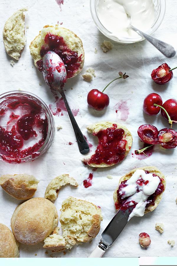 Scones With Cherry Jam And Clotted Cream Photograph by Marie Sjoberg