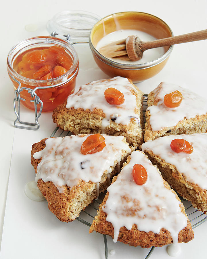 Scones With Icing And Candied Kumquats Photograph by Hannah Kompanik