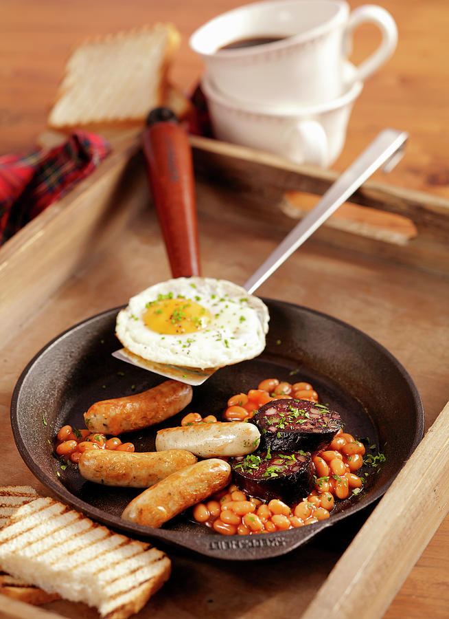 Scottish Breakfast With Baked Beans, Black Pudding, Bratwurst And A Fried Egg Photograph by Teubner Foodfoto