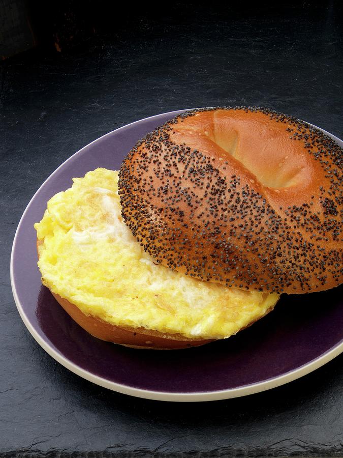 Scrambled Egg On A Poppy Seed Roll For Breakfast Photograph by Paul Poplis