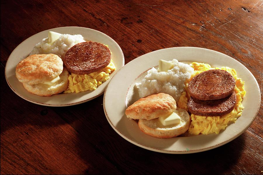 Scrambled Eggs With Sausages, Grits And American Biscuits Photograph by Colin Cooke