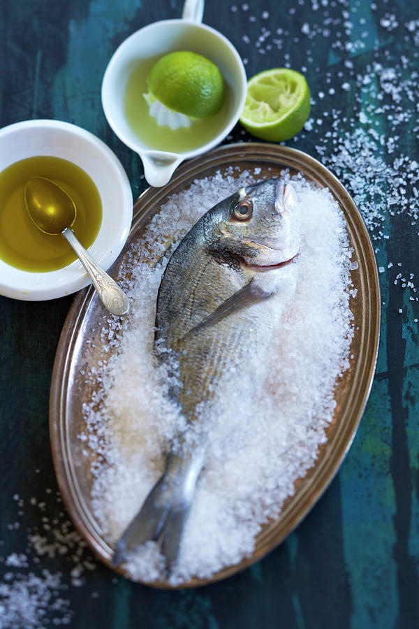 Sea Bream In Salt With Olive Oil And Limes Photograph by Sven C. Raben