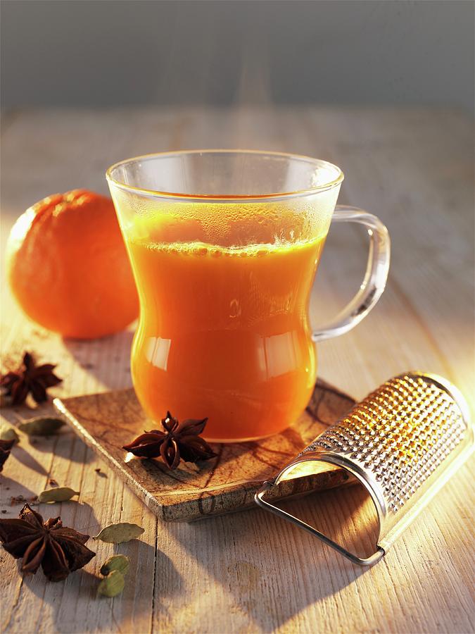 Sea-buckthorn Punch With Orange And Star Anise Photograph by Manfred Jahrei