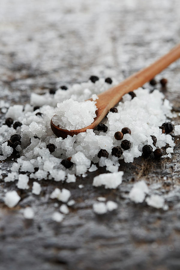 Sea Salt And Black Peppercorns With A Wooden Spoon Photograph by Rafael Pranschke