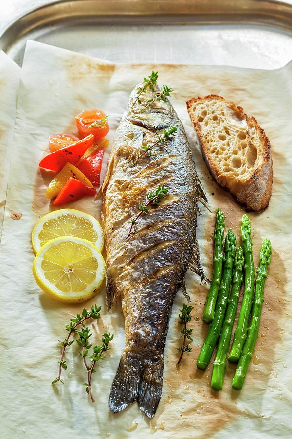 Seabass With Asparagus, Lemons And Bread On Baking Paper Photograph by Lukasz Zandecki
