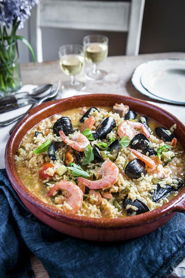 Seafood Paella In A Large Terracotta Dish Photograph by Magdalena Hendey