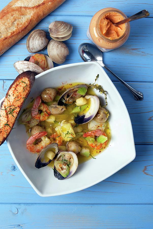 Seafood Soup With Shrimps, Clams And Potatoes Photograph by Spyros Bourboulis