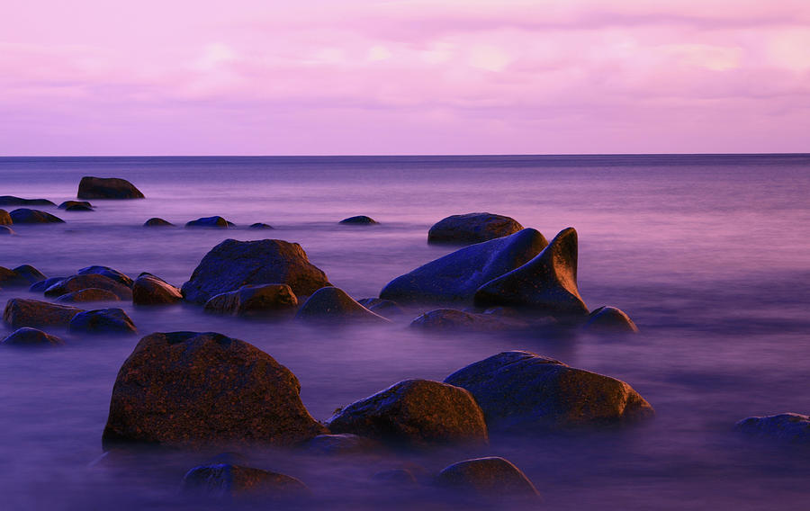 Seascape With Some Rocks Protruding The Photograph by Imaginegolf