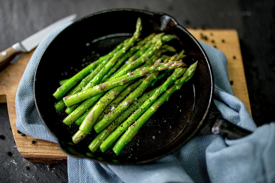 Seasoned Asparagus In Pan Photograph by Nicky Corbishley