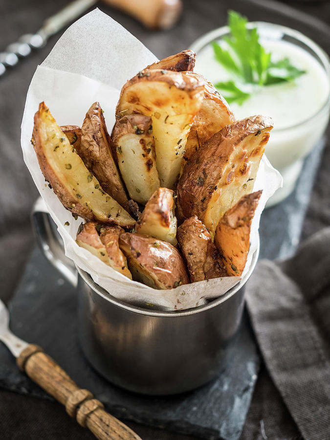 Seasoned Baked Potatoes Wedges Served With Garlic Dip Photograph by Magdalena Paluchowska