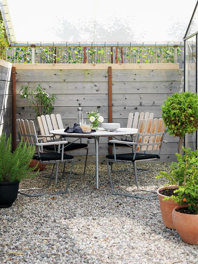 Seating Area On Small Gravel Terrace Below Awning With Wooden Frame Photograph by Peter Carlsson