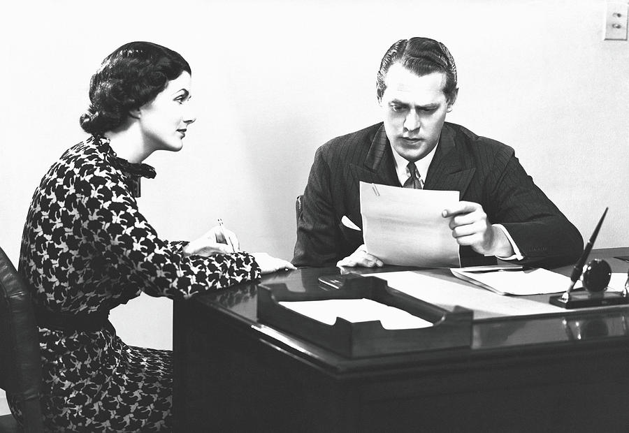 Secretary Assisting Businessman Reading Photograph by George Marks