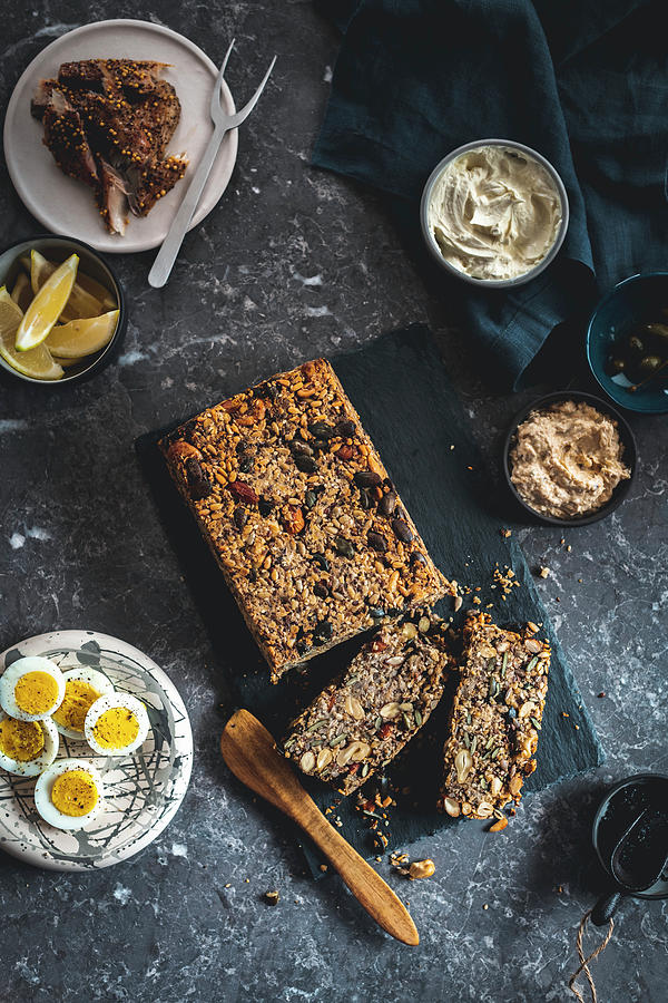 Seeded Bread With Nuts, Two Slices Cut With Fish, Eggs And Dips Photograph by Hein Van Tonder