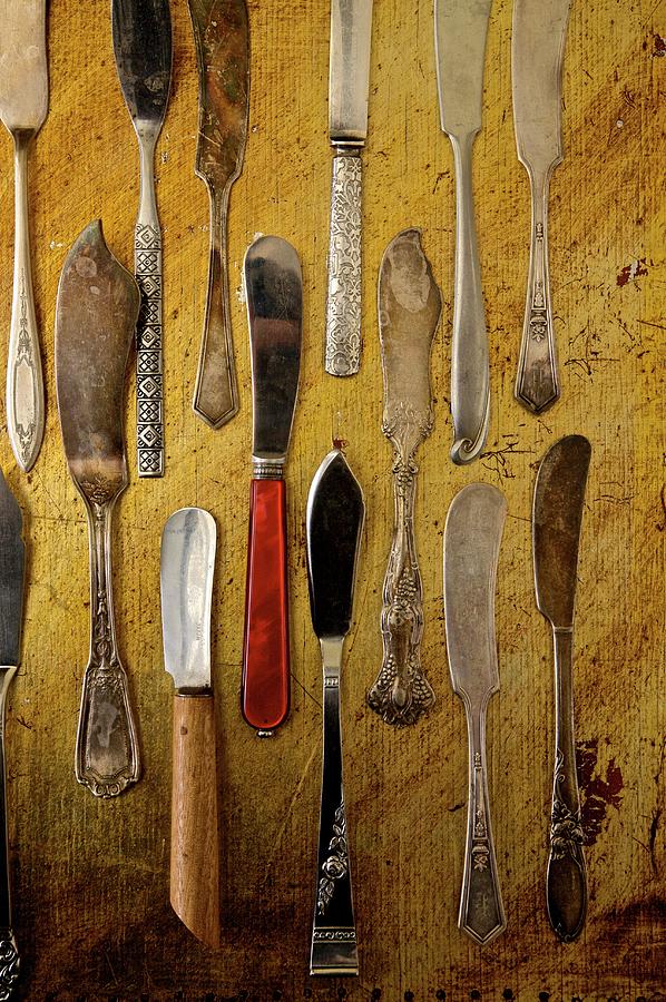 Selection Of Antique Butter Knives On A Rustic Board Photograph by Andre Baranowski