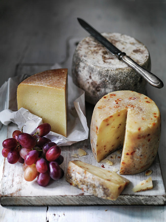 Selection Of Pecorino Sheep Cheeses With Red Grapes Photograph by Michael Paul