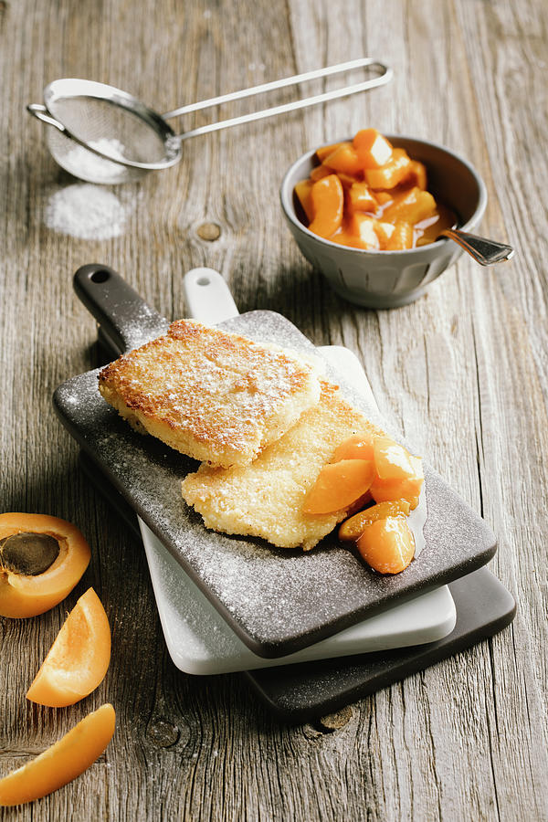 Semolina Slices With Apricot Compote And Icing Sugar Photograph by Jennifer Braun