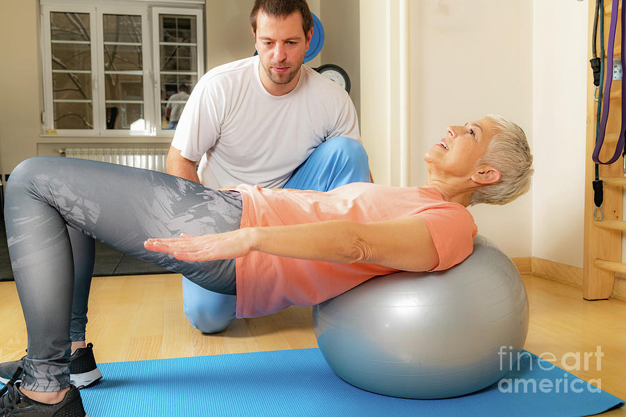 Senior Woman Exercising On Pilates Ball Photograph by Microgen Images/science Photo Library